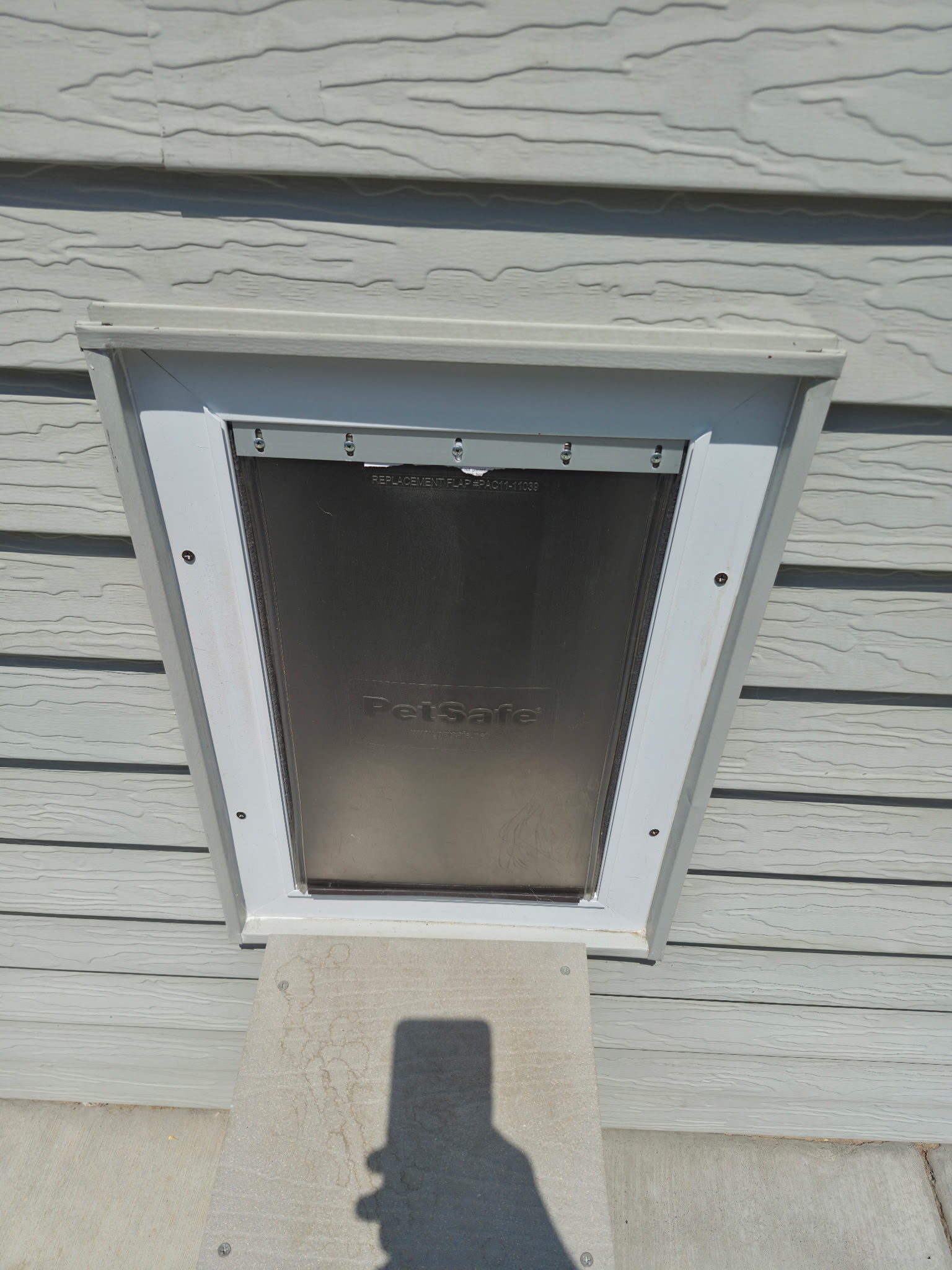 Pet door through exterior vinyl siding
